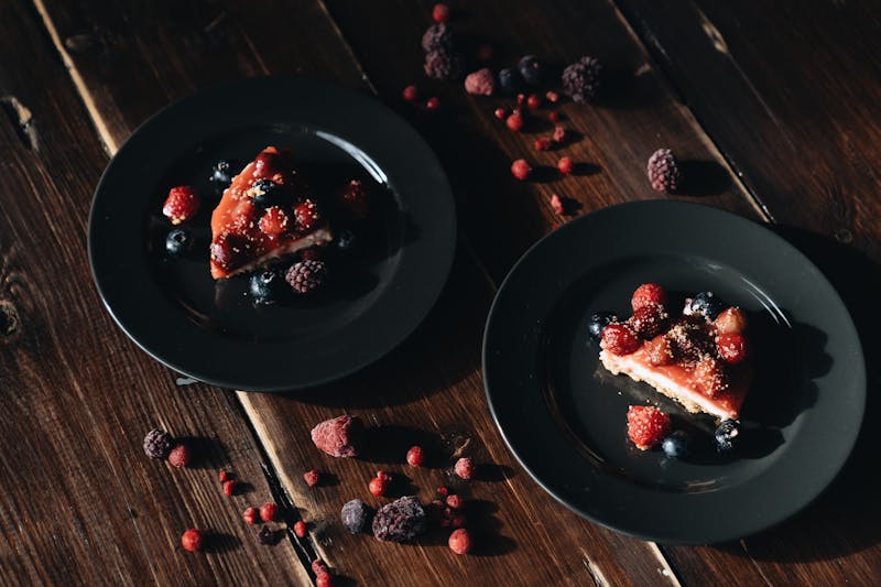 New York style cheesecake slice with berry compote